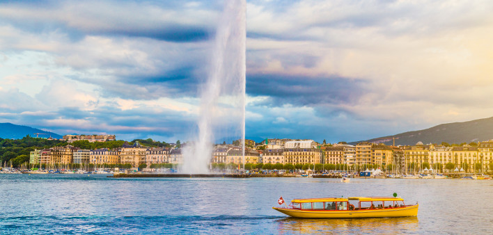 City of Geneva with Jet d'Eau fountain at sunset, Switzerland
