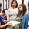 Young Latina girl and mother listen to nurse