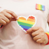 hands holding LGBT colored heart