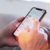 hands holding phone showing calendar