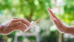 lose up of male hands holding cigarettes and proposing it to person.