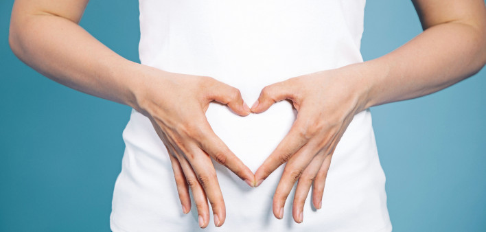 woman making shape of heart with her hands