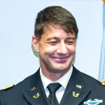 The commissioning of Nick Harrison, center, as an officer in the U.S. Army in Washington, DC, on August 5. Lambda Legal CEO Kevin Jennings, left, attends.