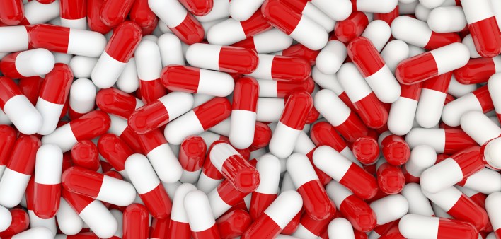 A pile of red and white capsules
