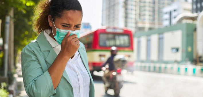 African American women wearing masks face dust Smoke problems on the road in the capital. stock photo City, Coughing, Pollution, Adult, Adults Only