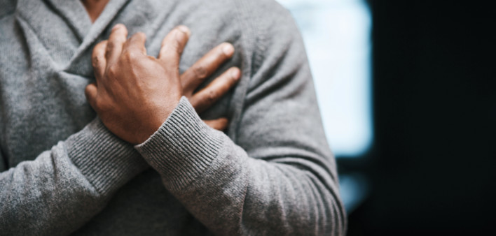 African American Man holding chest pain heart