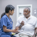 nurse talking to black doctor