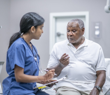 nurse talking to black doctor