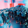 vials of vaccine on assembly line factory
