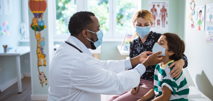 Close up of a pediatrician having a check up on his patient