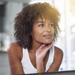 An African American woman looking in a mirror