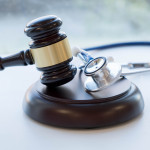 Gavel and stethoscope. medical jurisprudence. legal definition of medical malpractice. attorney. common errors doctors, nurses and hospitals make