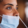 woman getting a nasal swap covid test