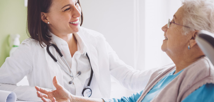 female doctor with older female patient