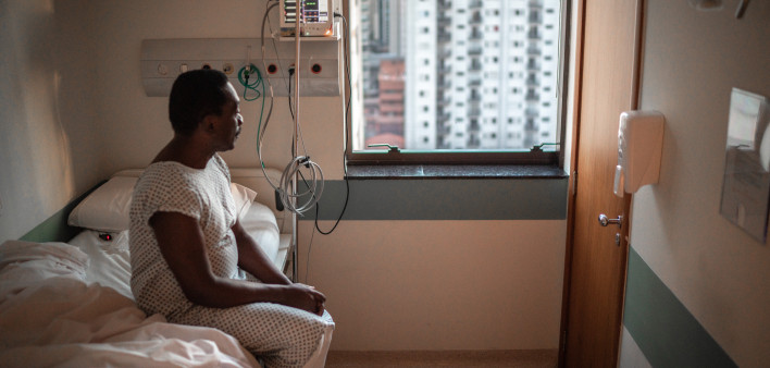 black patient in the hospital sitting in bed