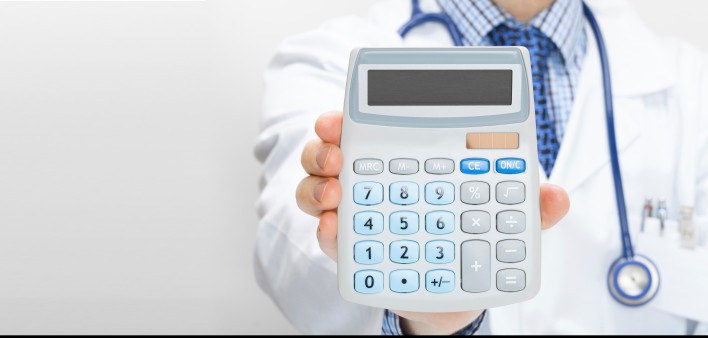A hand holding up a calculator
