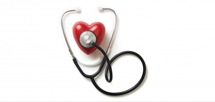 A stethoscope on a red plastic heart