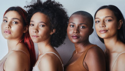 Black women tudio shot of a group of beautiful young women posing together against a gray background