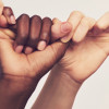 5 hands clasped together by linking fingers