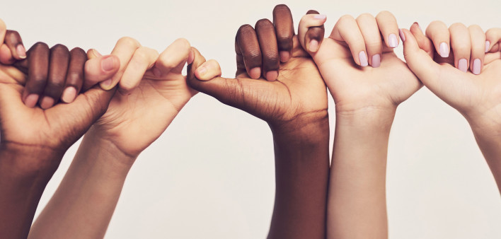 5 hands clasped together by linking fingers