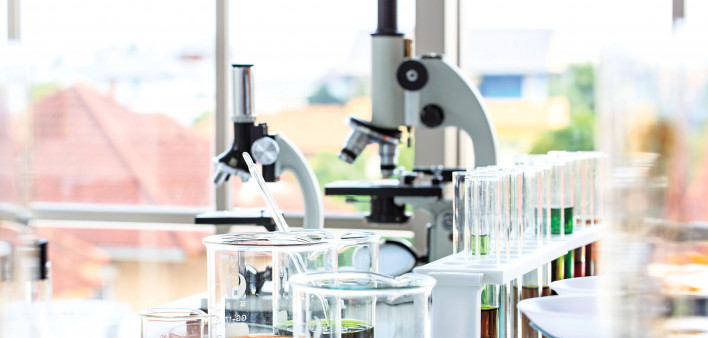 beakers and microscopes in laboratory