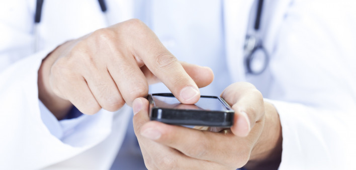  a doctor touching a smart phone