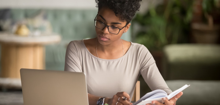 woman sitting at table with labtop