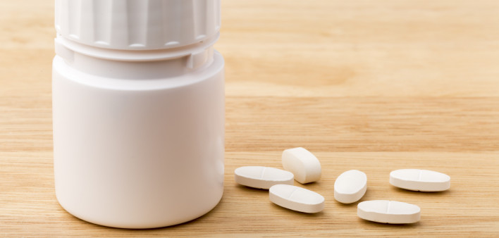 white pills and pill bottle medication generic image