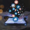 social media hands on phone with icons