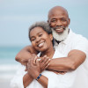 smiling man and woman embrace on beach