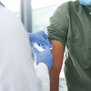 doctor gives a patient a syringe