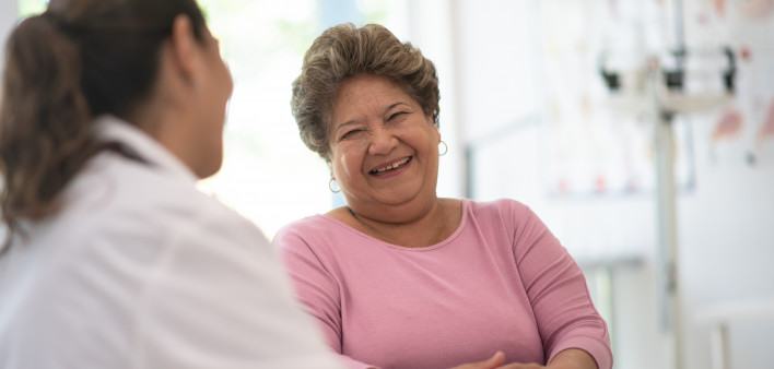 Older Woman talking with the Doctor laughing