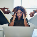 Shot of a stressed out young woman working in a demanding career