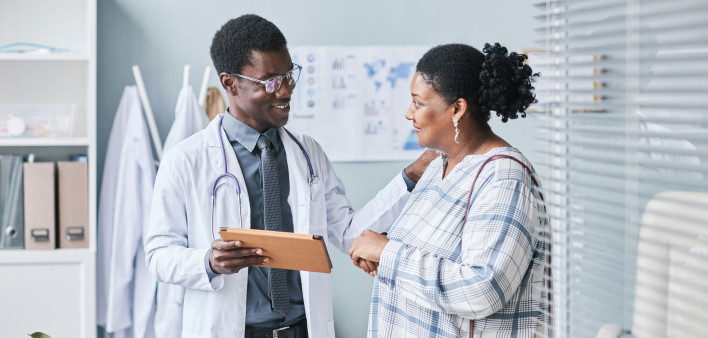 Young African American doctor consulting female patient