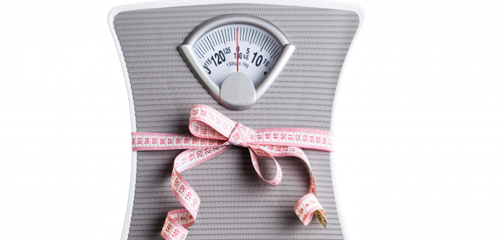 scale squeezed by tape measure weight loss