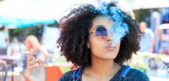 African American woman smoking in cafeteria
