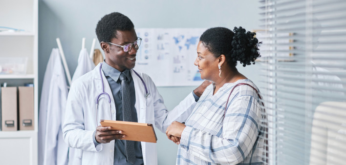 Young African American doctor consulting female patient