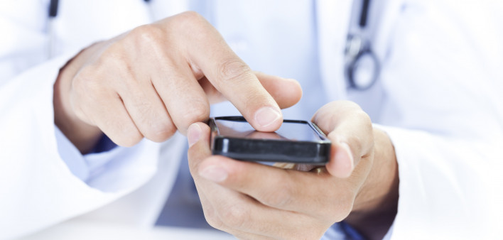  a doctor touching a smart phone
