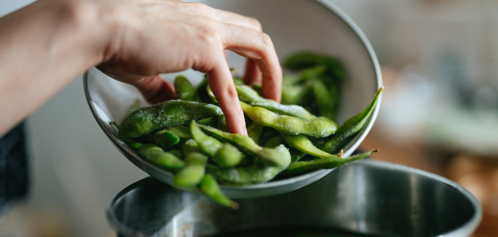 Close Up Photo Of Woman Hands Adding Edamame To The Pot