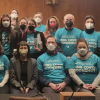 Members of the group Long COVID Moonshot and other advocates and researchers pose in the Senate building, wearing T-shirts advertising the need for moonshot-level funding.