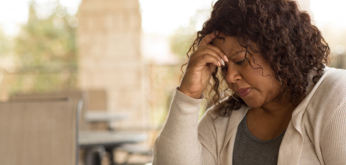 African American middle age woman looking sad.