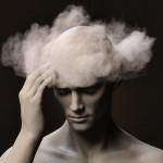 Brain Fog A make figure with his right hand on his temple pained expression