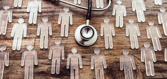 photo illustration figures and stethoscope on wood