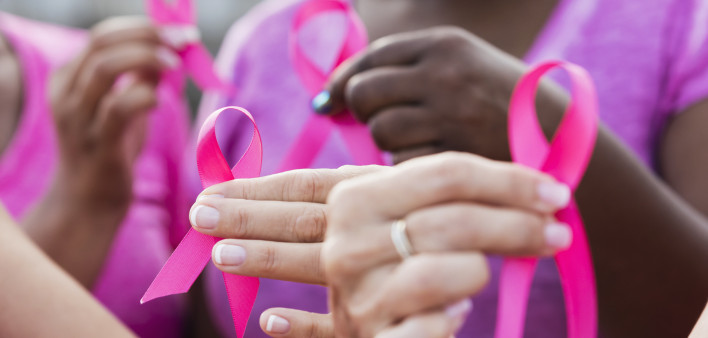 Multi-ethnic women with breast cancer awareness ribbons
