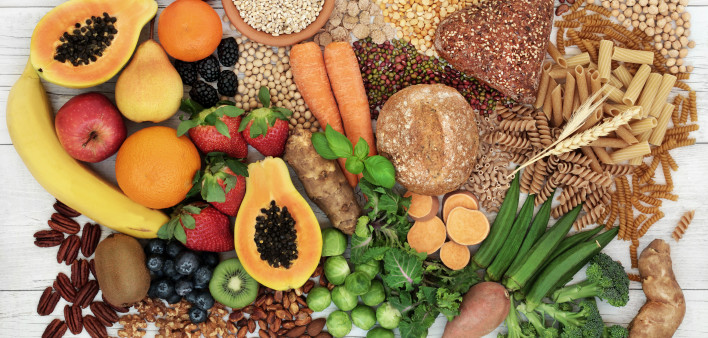 food with high fiber content for a healthy diet with fruit, vegetables, whole wheat bread, pasta, nuts, legumes, grains and cereals