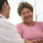 Older Woman talking with the Doctor laughing