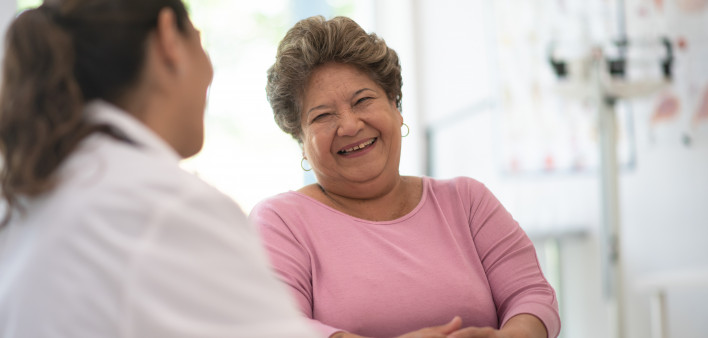 Older Woman talking with the Doctor laughing