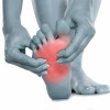 Woman massaging her painful foot neuropathy