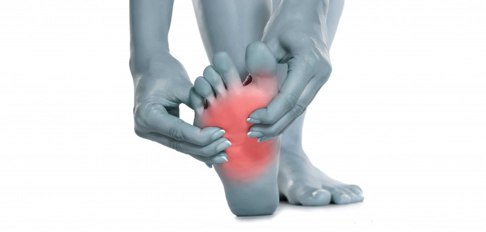 Woman massaging her painful foot neuropathy