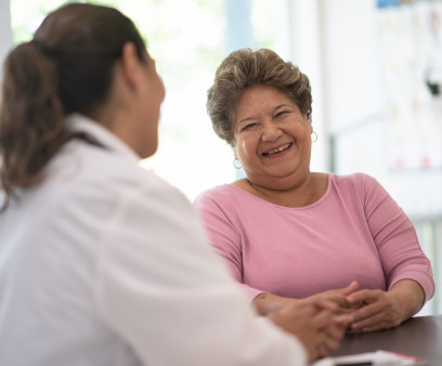 Older Woman talking with the Doctor laughing